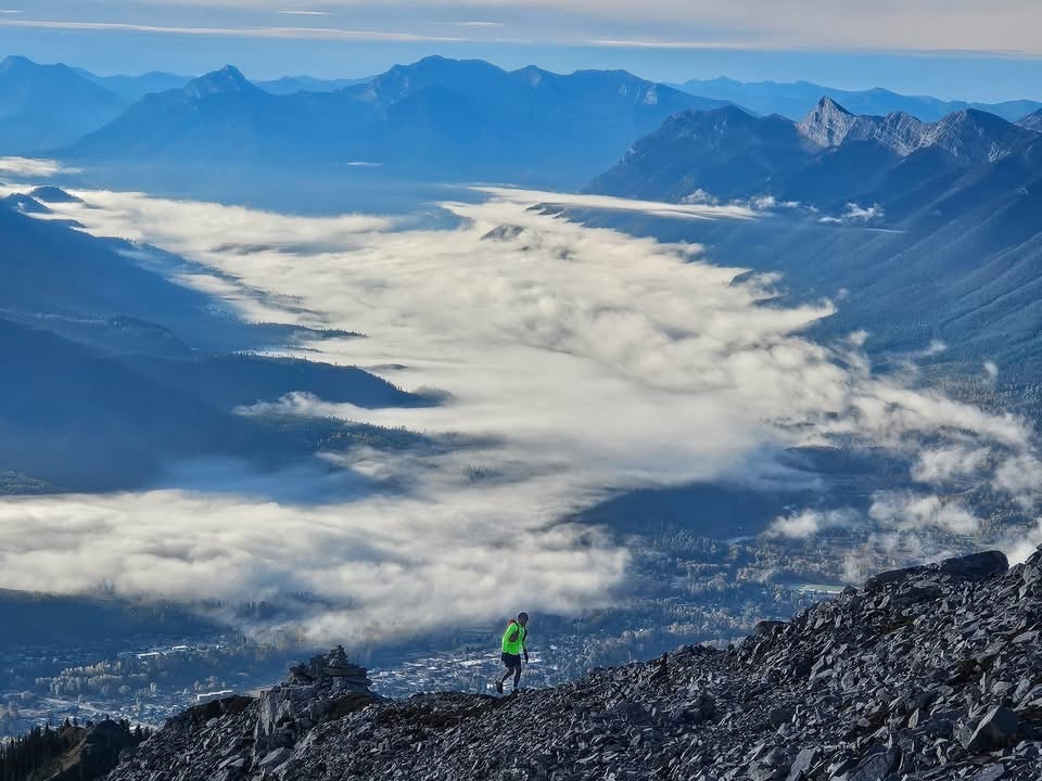Harshan running above Fernie on a mountain summit