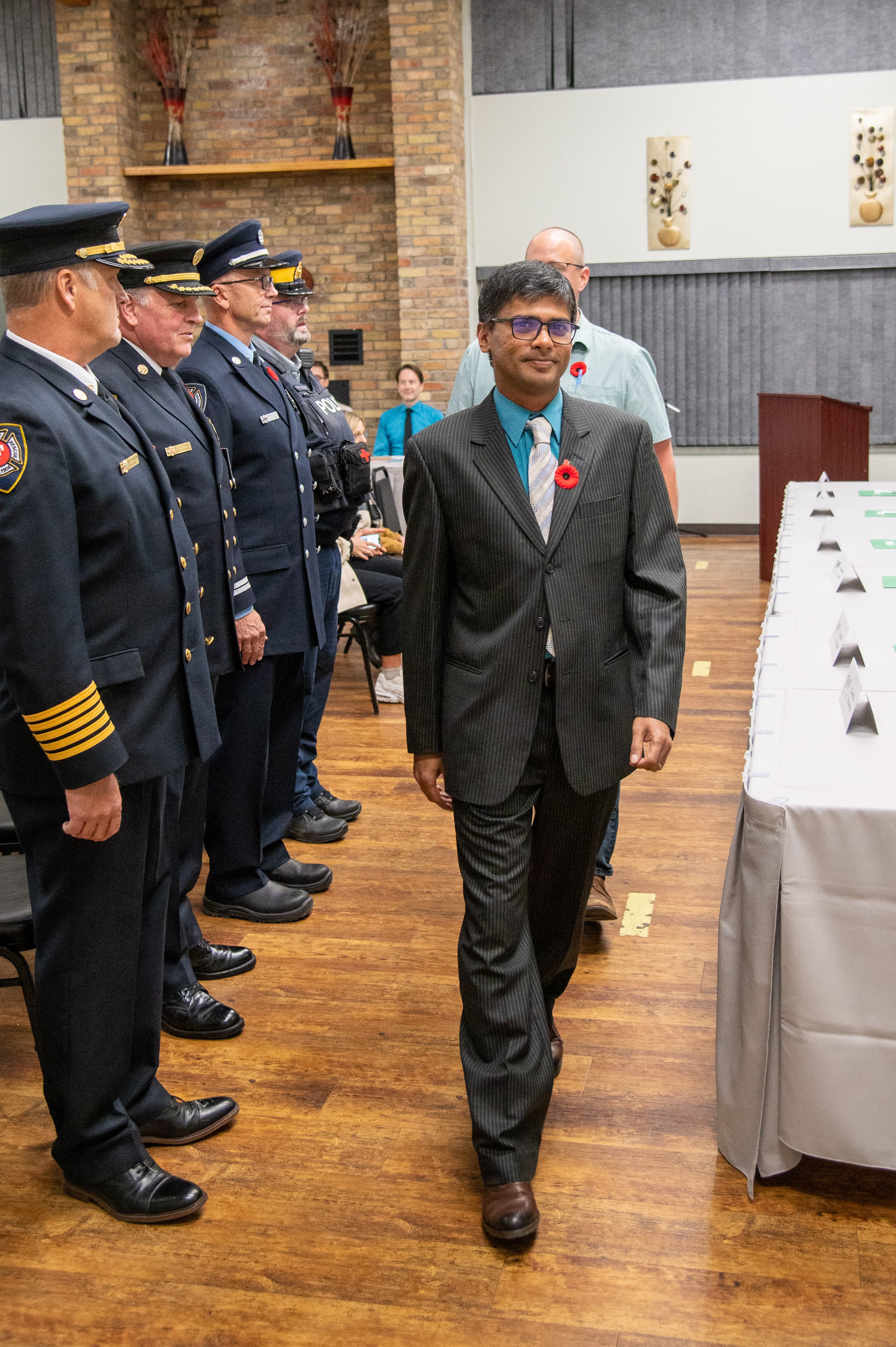Harshan Ramadass at an official civic ceremony with uniformed officials